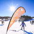 Person skiing on a snowy slope with a Discover Ski & Board banner in the foreground.